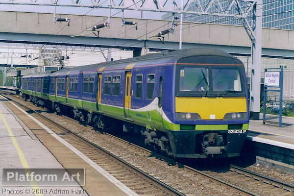 Silverlink County unit 321424 leaves Milton Keynes Central with a Birmingham - London Euston semi-fast service on 14th April 2004.
