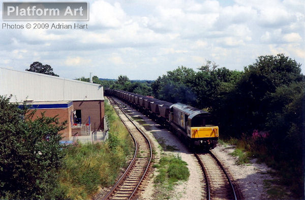 Class 58 locomotive 58002 Daw Mill Colliery is seen approaching Penkridge on 22nd July 1992 with the 7T59 15.20 loaded MGR coal service from Littleton Colliery to Bescot. The colliery closed in December 1993.