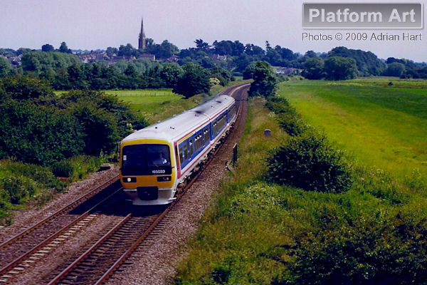 Network South East liveried Class 165 165033 leaves Kings Sutton with the 13.45 London Marylebone - Birmingham Snow Hill service on 20th June 1998.