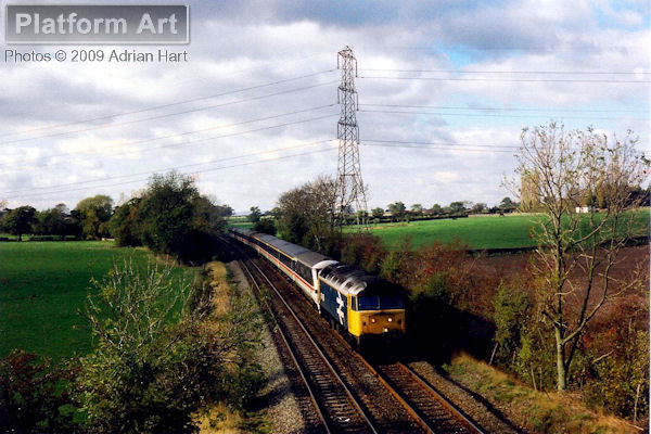 On 3rd November 1990, the 11.32 Shrewsbury - London Euston is seen near Oaken in Shropshire with Class 47 47456 leading DVT 82104.