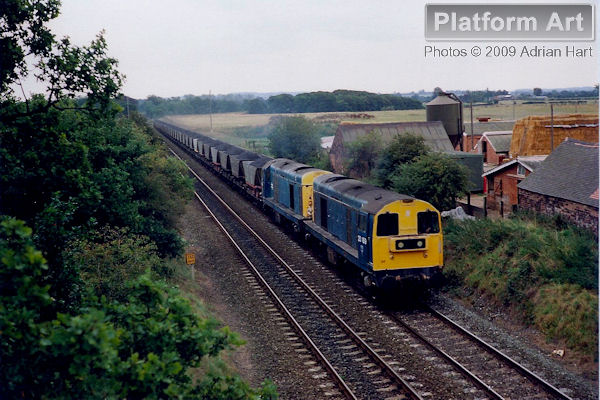 Class 20 locomotives 20169 and 20045 pass Bonemill Bridge between Cosford and Shifnal on 15th September 1990, with a loaded MGR coal train from Silverdale Colliery in Staffordshire to Ironbridge Power Station.