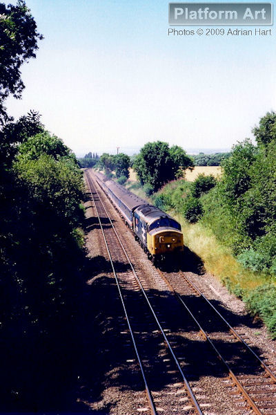 Class 37 37429 Eisteddfod Genediaethol powers the 10.13 Pwllheli - London Euston service east of Albrighton on 14th July 1990.