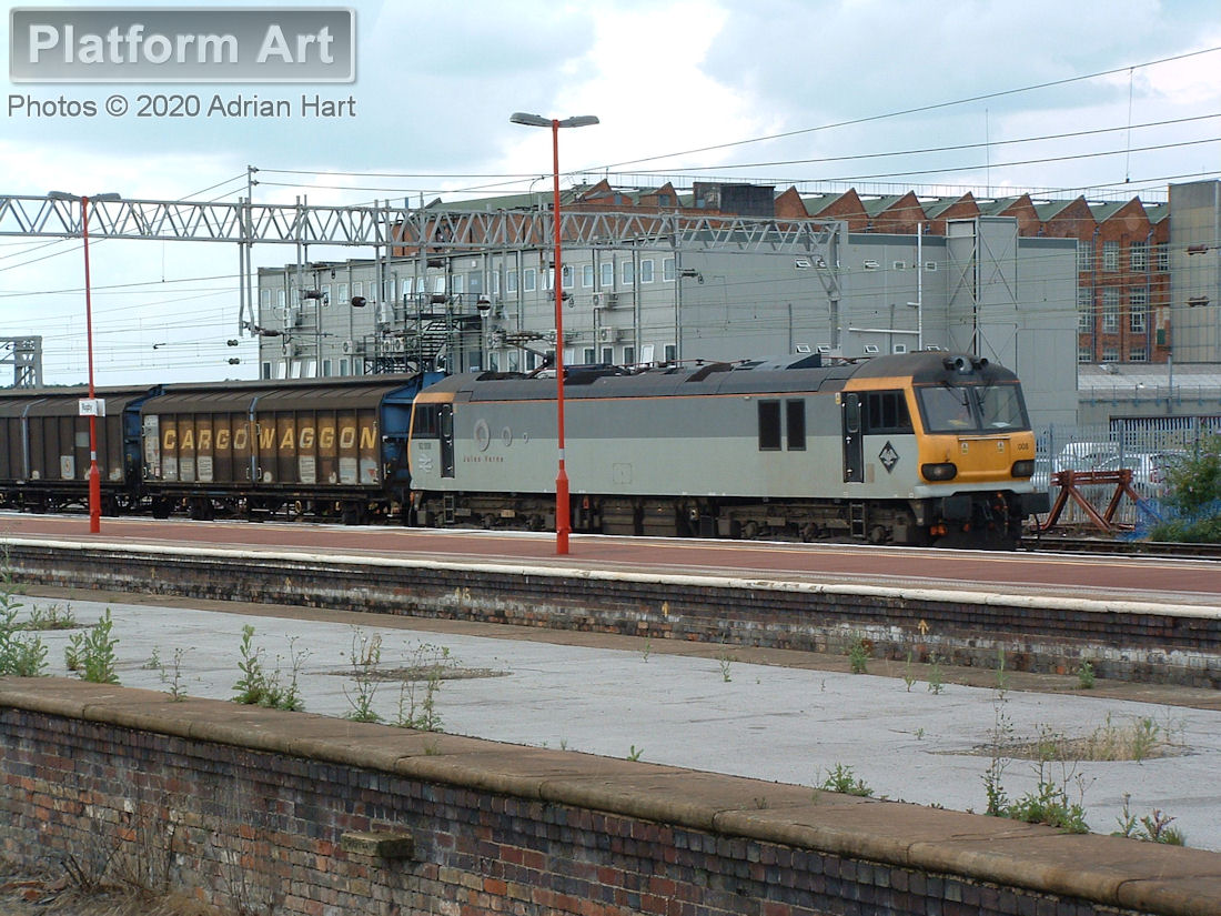 EWS Class 92 locomotive 92008 Jules Verne passes Rugby on 19th July 2004, with what is believed to be the 6A42 15.24 Bescot - Wembley Enterprise service. The former Alstom/GEC works in the background have now been demolished.