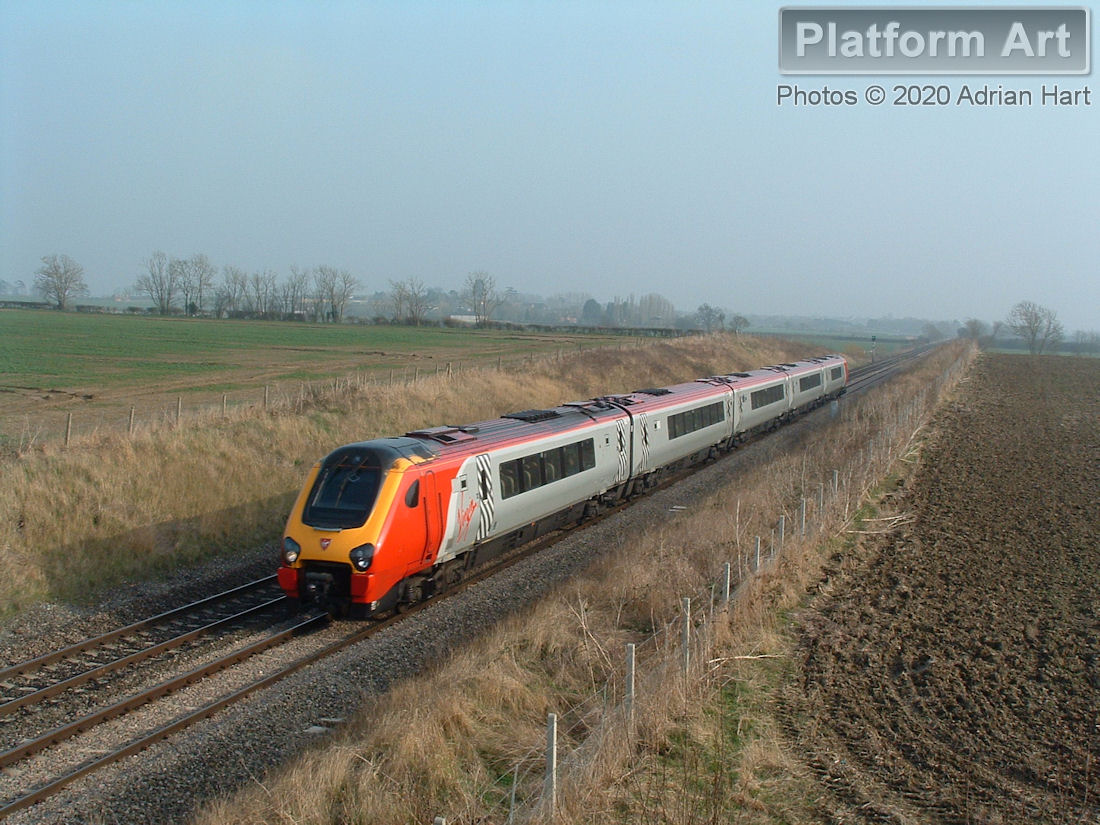 An unidentified Class 221 Voyager unit passes Croome Perry in Worcestershire in hazy conditions on 19th March 2005, with a northbound Virgin Cross Country service.