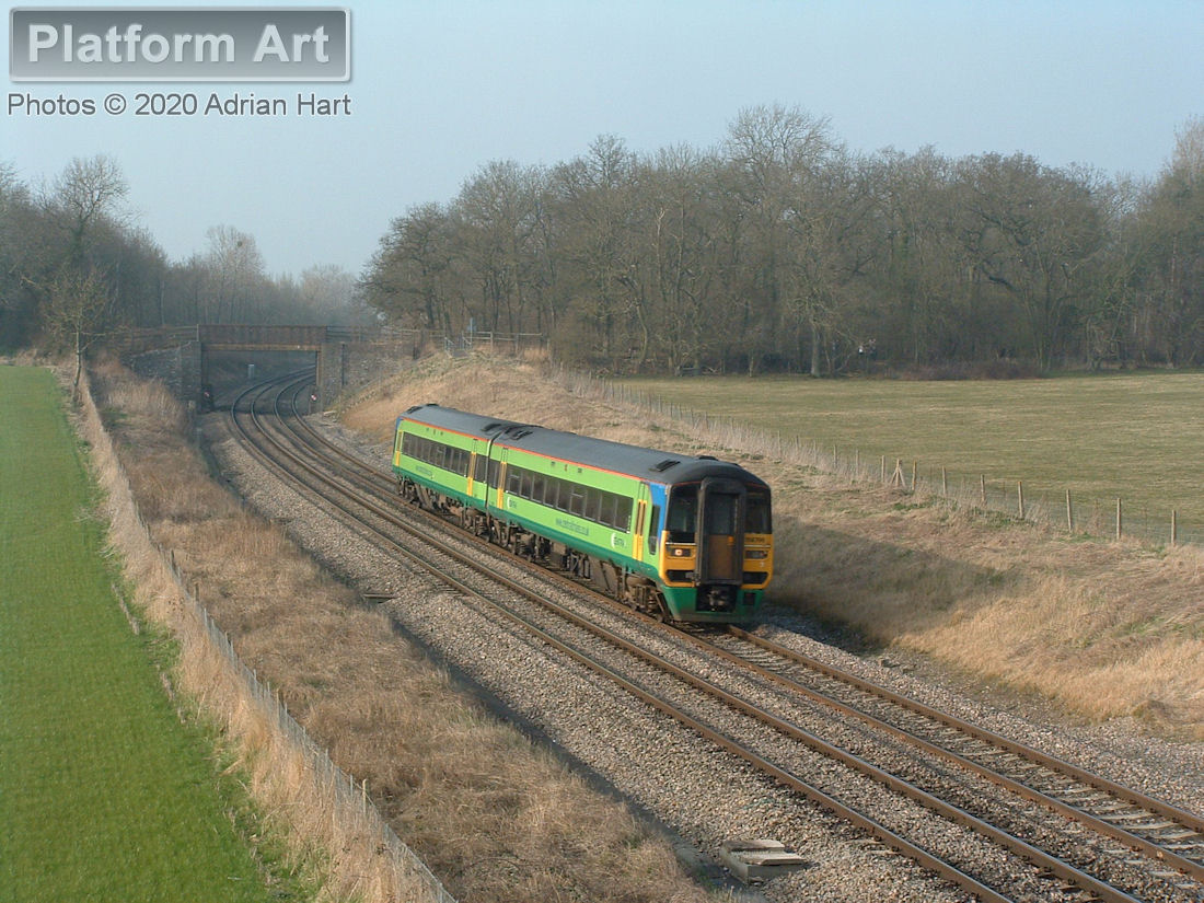 Two-car Class 158 unit 158796 passes Croome Perry Wood on 19th March 2005, with a southbound Central Trains service.